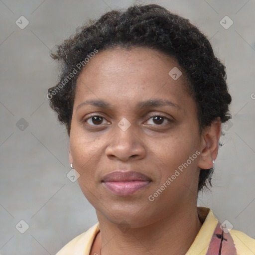 Joyful black adult female with short  brown hair and brown eyes