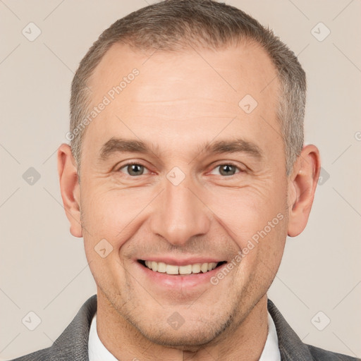 Joyful white adult male with short  brown hair and brown eyes