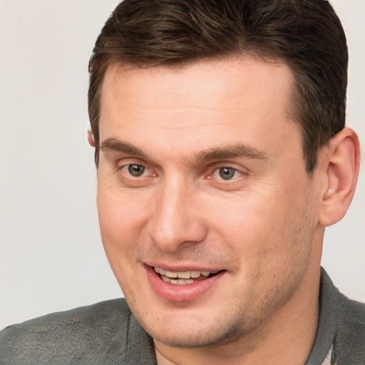 Joyful white adult male with short  brown hair and brown eyes