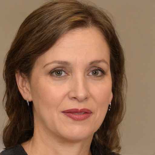 Joyful white adult female with medium  brown hair and grey eyes