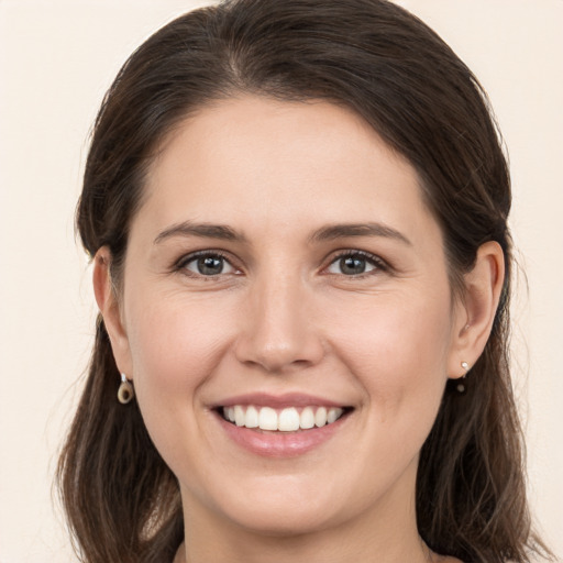 Joyful white young-adult female with medium  brown hair and brown eyes