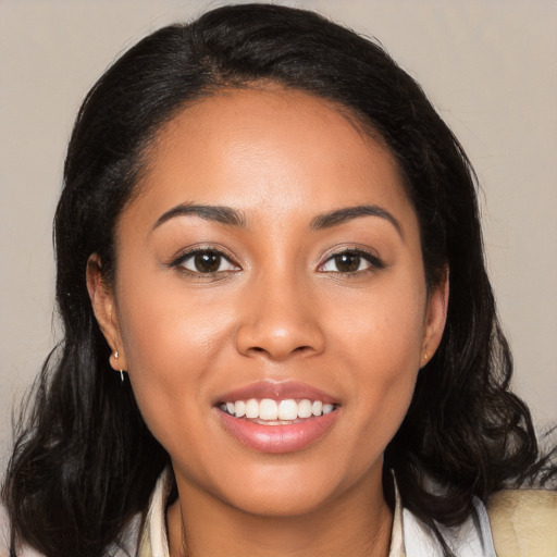 Joyful latino young-adult female with long  black hair and brown eyes