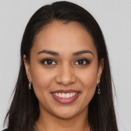 Joyful latino young-adult female with long  brown hair and brown eyes