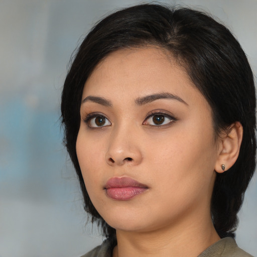 Neutral latino young-adult female with medium  black hair and brown eyes