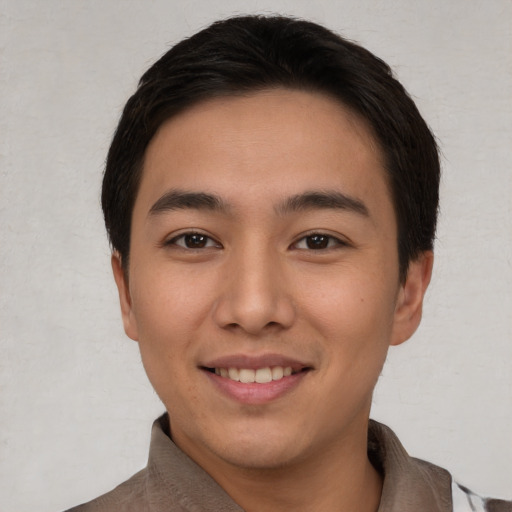 Joyful asian young-adult male with short  brown hair and brown eyes
