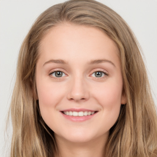 Joyful white young-adult female with long  brown hair and green eyes