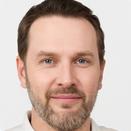 Joyful white adult male with short  brown hair and grey eyes