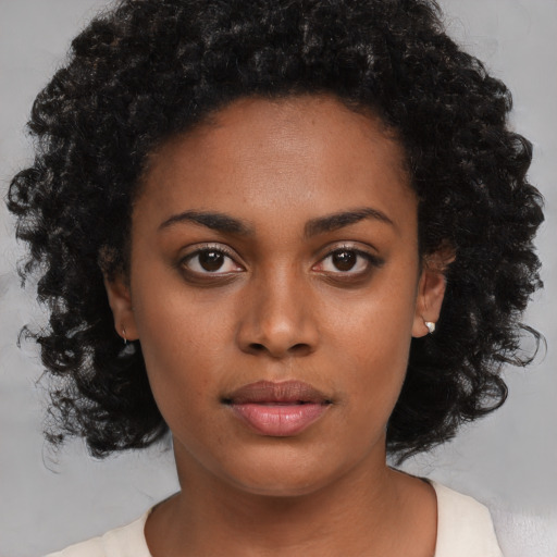 Neutral black young-adult female with medium  black hair and brown eyes