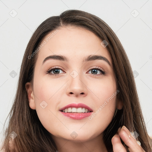 Joyful white young-adult female with long  brown hair and grey eyes