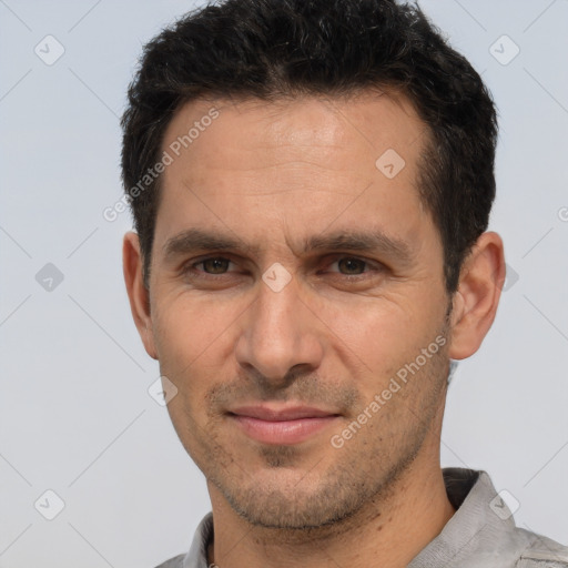 Joyful white adult male with short  brown hair and brown eyes