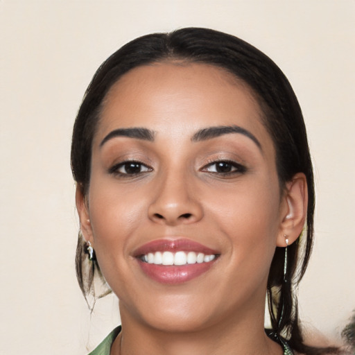 Joyful latino young-adult female with medium  black hair and brown eyes