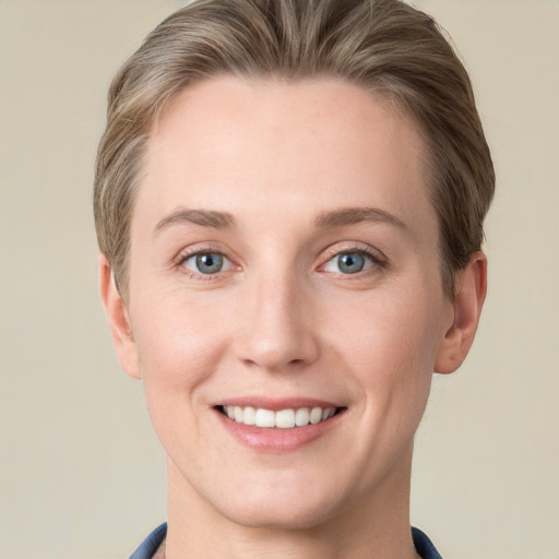 Joyful white young-adult female with short  brown hair and grey eyes