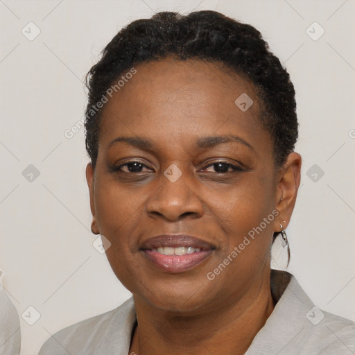 Joyful black adult female with short  brown hair and brown eyes