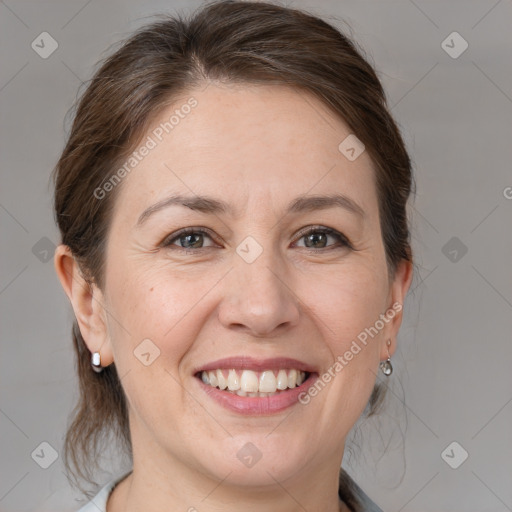 Joyful white adult female with medium  brown hair and grey eyes