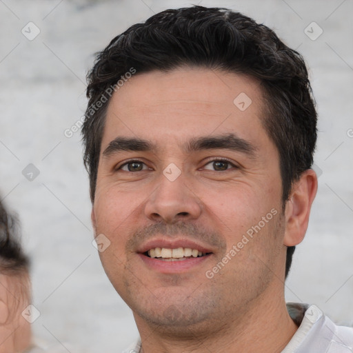 Joyful white young-adult male with short  black hair and brown eyes