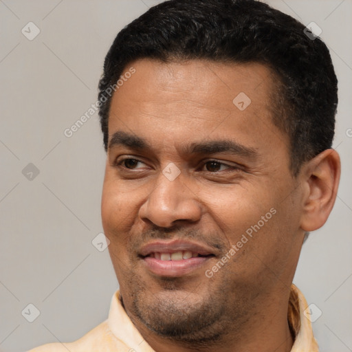 Joyful latino adult male with short  black hair and brown eyes