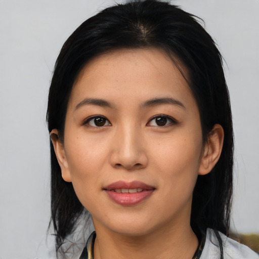 Joyful asian young-adult female with medium  black hair and brown eyes