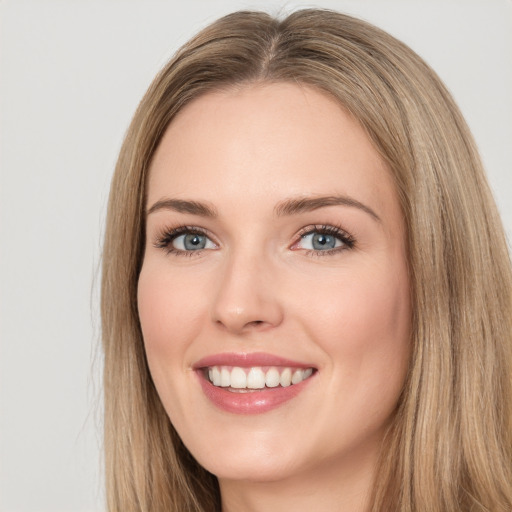 Joyful white young-adult female with long  brown hair and green eyes