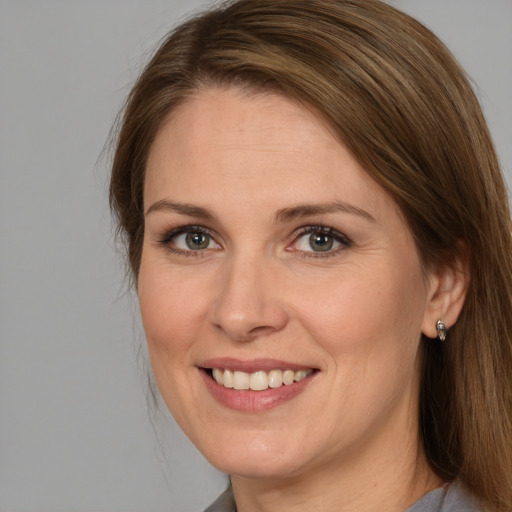 Joyful white adult female with medium  brown hair and brown eyes