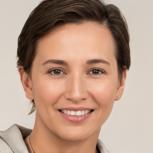 Joyful white young-adult female with short  brown hair and brown eyes