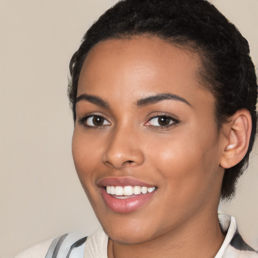 Joyful latino young-adult female with short  black hair and brown eyes