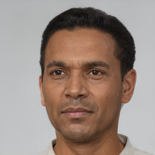 Neutral latino adult male with short  black hair and brown eyes