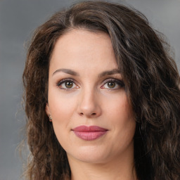 Joyful white young-adult female with long  brown hair and green eyes