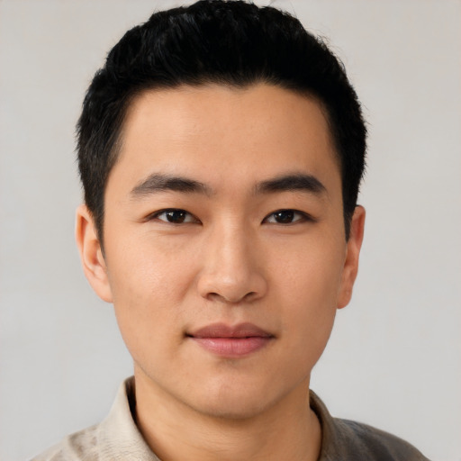 Joyful asian young-adult male with short  black hair and brown eyes