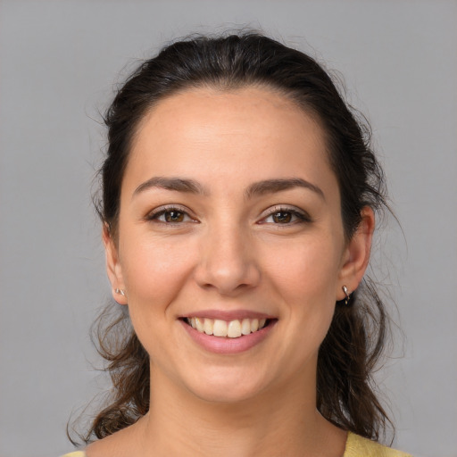 Joyful white young-adult female with medium  brown hair and brown eyes