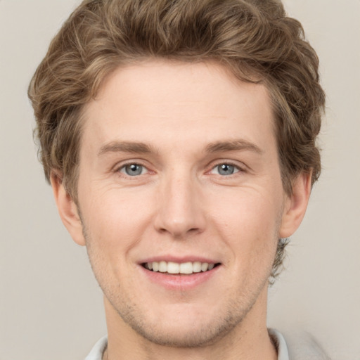 Joyful white adult male with short  brown hair and grey eyes