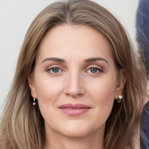 Joyful white young-adult female with long  brown hair and grey eyes