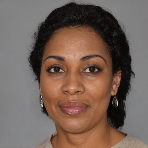 Joyful black adult female with medium  black hair and brown eyes