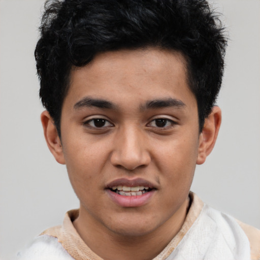 Joyful latino young-adult male with short  black hair and brown eyes