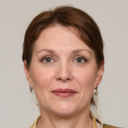 Joyful white adult female with medium  brown hair and grey eyes