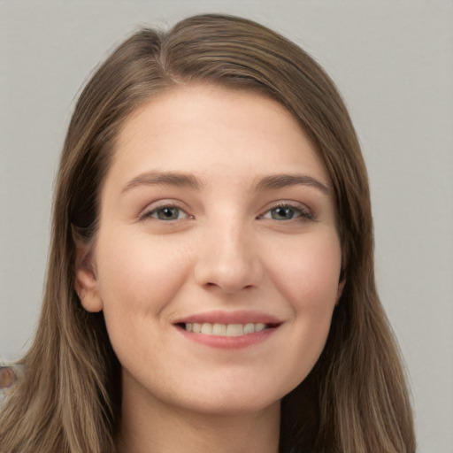 Joyful white young-adult female with long  brown hair and grey eyes