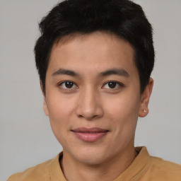 Joyful asian young-adult male with short  black hair and brown eyes