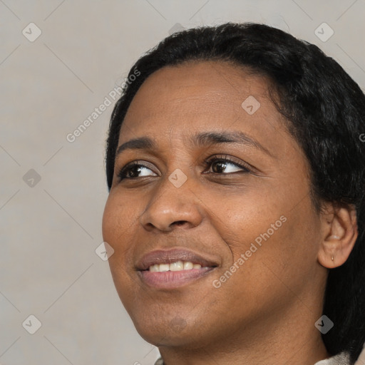 Joyful black young-adult female with short  black hair and brown eyes