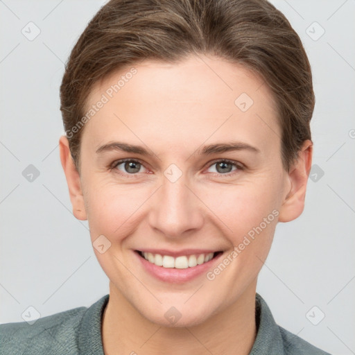 Joyful white young-adult female with short  brown hair and grey eyes