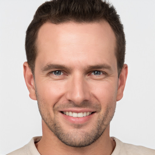 Joyful white young-adult male with short  brown hair and brown eyes