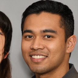 Joyful asian young-adult male with short  brown hair and brown eyes