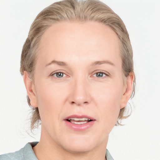 Joyful white adult female with medium  brown hair and grey eyes