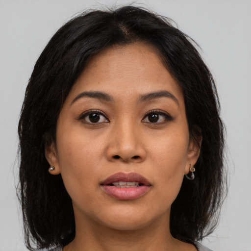Joyful asian young-adult female with medium  brown hair and brown eyes
