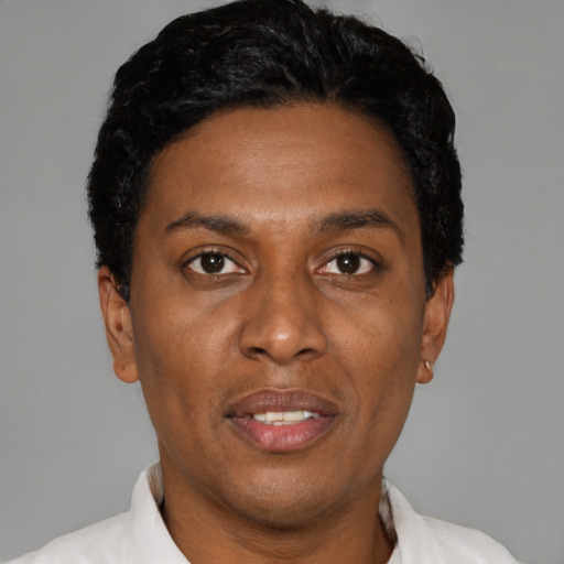 Joyful black young-adult male with short  black hair and brown eyes