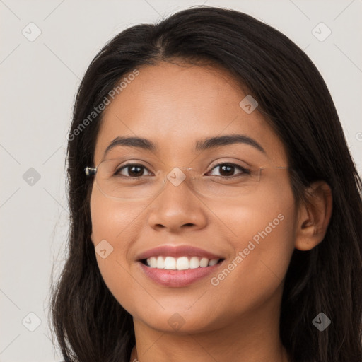 Joyful latino young-adult female with long  brown hair and brown eyes