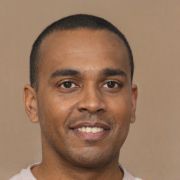 Joyful latino young-adult male with short  brown hair and brown eyes