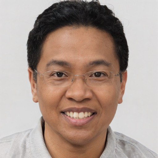 Joyful asian adult male with short  black hair and brown eyes