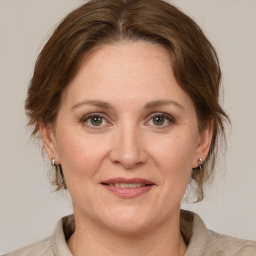 Joyful white adult female with medium  brown hair and grey eyes