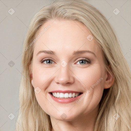 Joyful white young-adult female with long  brown hair and blue eyes