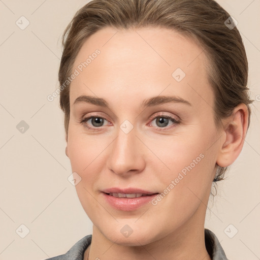 Joyful white young-adult female with medium  brown hair and grey eyes