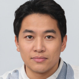 Joyful asian young-adult male with short  brown hair and brown eyes